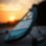 A sleek wing foil board displayed against a sunset backdrop