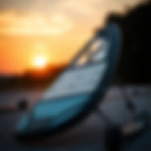 A sleek wing foil board displayed against a sunset backdrop