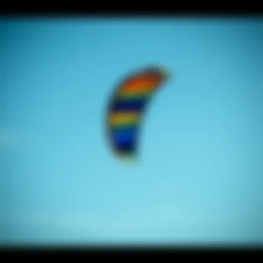 Kite Aerodynamics A colorful kite soaring high against a clear blue sky, showcasing aerodynamics and design.