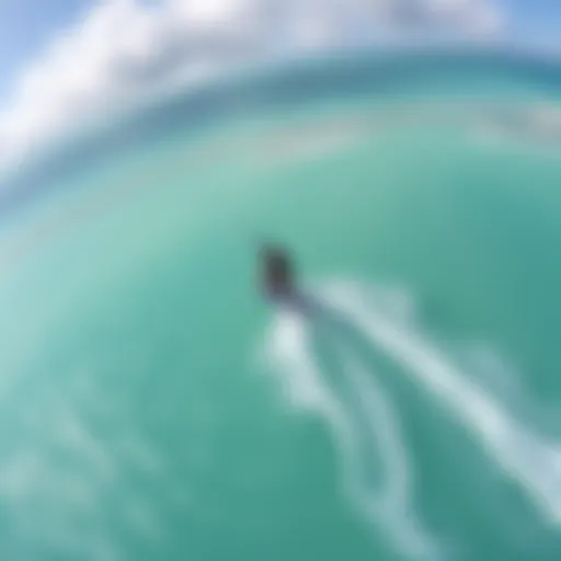 Stunning aerial view of a kiteboarder gliding over turquoise waters