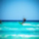 Kite surfer gliding over turquoise waters