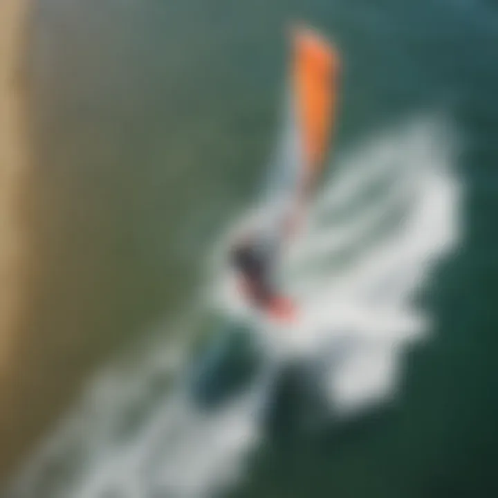An aerial view of kite surfers navigating the waves, showcasing the dynamic nature of the sport in Santa Barbara.