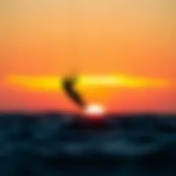 A kitesurfer riding the waves against a stunning sunset backdrop
