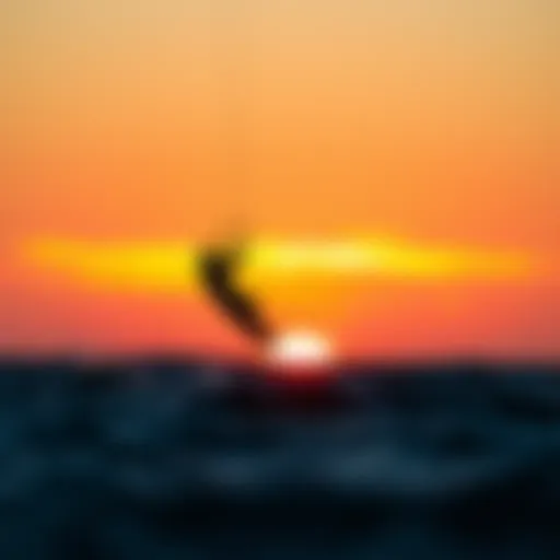 A kitesurfer riding the waves against a stunning sunset backdrop