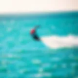 A vibrant kite soaring above turquoise waters during a kiteboarding session