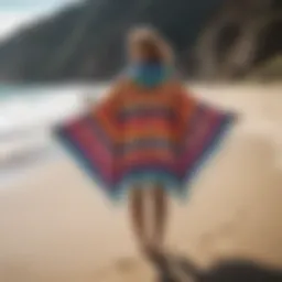 A vibrant Mystic Surf Poncho displayed on a sandy beach.