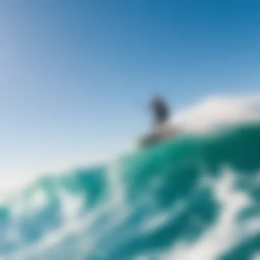Gliding Over Waves A thrilling wingboarder gliding over the waves under a clear blue sky