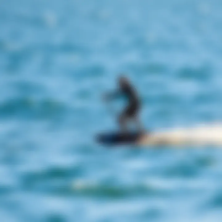 A serene water scene with a surfer practicing safe foilboarding