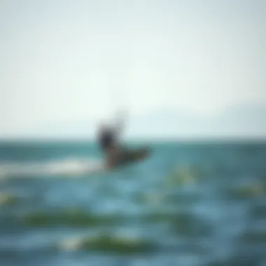 A serene scene of a kiteboarder gliding smoothly on the water