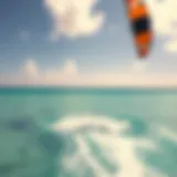 A vibrant kite soaring in the sky above crystal-clear waters