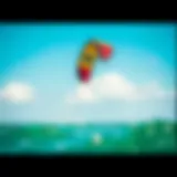 Experience the Thrill of Kiteboarding A vibrant kite soaring above the water