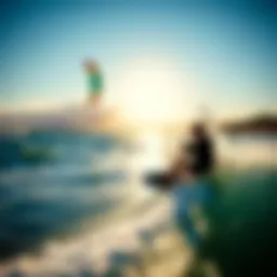 Kiteboarder riding a wave with a vibrant kite in the sky