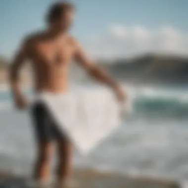 Surfer Utilizing Towel for Changing A surfer changing clothes using a surf towel for privacy