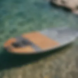 A high-quality foil board ready for kiteboarding on a tranquil water surface.