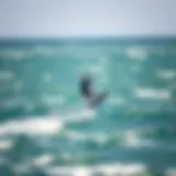 A stunning view of a kite soaring high above the waves during a kiteboarding session