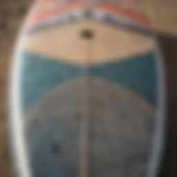 A close-up view of the surface of a used kite board showcasing its design and wear.