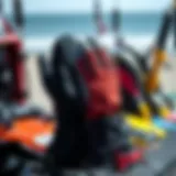 Wetsuit mittens displayed with kiteboarding gear